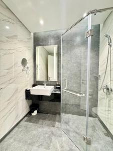 a bathroom with a glass shower and a sink at Altara Residences Apartment - Tầng Cao View Biển Cực Chill in Quy Nhon +12 photos