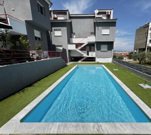 a swimming pool in the backyard of a house at Barounia Suite in Iraklitsa