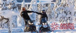 two people standing in the snow with their snowmobiles at Luxury City Apartments, Korkalonkatu in Rovaniemi +1 photo