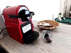 a red toaster sitting on top of a table at Studio Ocean in Paralia Dionysiou