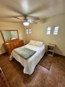 a bedroom with a bed and a ceiling fan at Oceanfront House Surf and Relax in San Miguel