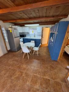 a kitchen with a table and chairs in a room at Oceanfront House Surf and Relax in San Miguel +9 photos