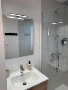 a white bathroom with a sink and a shower at Chalet 15 in Saint-Genès-Champespe +31 photos