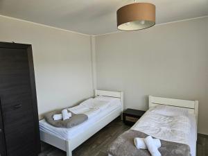 Postel nebo postele na pokoji v ubytování Biały Fortepian