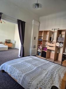 a bedroom with a bed and some shelves at Figaro in Ventspils
