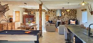 a living room with a pool table in it at Le Moulin Charme & Nature in Esplantas