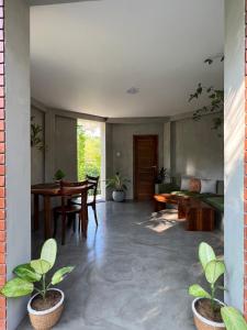 a living room with a table and some plants at Romantic Jungle Hideaway in Tangalle +30 photos