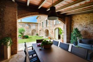 a dining room with a table and chairs in a building at Mas Piarnau in Vilasacra