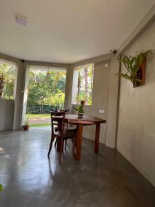 a dining room with a wooden table and chairs at Romantic Jungle Hideaway in Tangalle