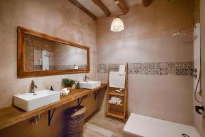 a bathroom with two sinks and a mirror at Mas Piarnau in Vilasacra +12 photos