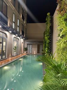 a large swimming pool in a building with plants at Villa Amanda 3 - City Center- Private swimming Pool in Phan Thiet