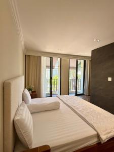 a large bedroom with two beds and a large window at Villa Amanda 3 - City Center- Private swimming Pool in Phan Thiet +32 photos