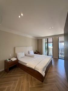 a bedroom with a large bed and a large window at Villa Amanda 3 - City Center- Private swimming Pool in Phan Thiet