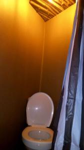 a bathroom with a white toilet in a room at Sabali in Rietfontein