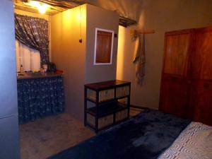 a small bedroom with a bed and a sink at Sabali in Rietfontein +6 photos