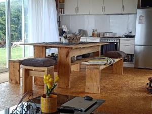 a kitchen with a wooden island in a kitchen at TeAraiMoana House - Aitutaki in Amuri