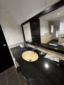 a bathroom with a sink and a large mirror at National Park Mutiara - Kuala tahan in Kuala Tahan +45 photos