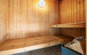 a wooden sauna with a wooden bench in it at 3 Bedroom Beautiful Home In Hjørring in Lønstrup