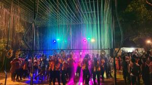 a group of people standing on a stage at night at Kottaram Heritage Resort in Alleppey