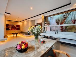 a kitchen with a vase of flowers on a counter at Modern 2 BR villa seminyak center. in Seminyak +27 photos