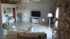 a living room with a couch and a flat screen tv at loft appartement dans bastide in La Celle-sous-Gouzon