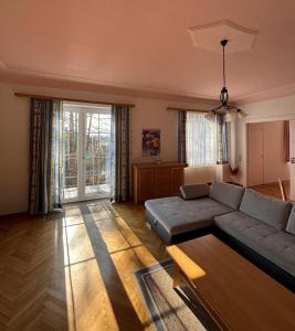 a living room with a couch and a table at Gästehaus Steiner in Spielberg