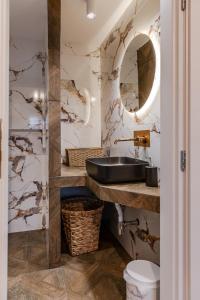 a bathroom with a black sink and a mirror at Delimare, Acropolis & Sea View Rooftop, Paleo Faliro in Athens