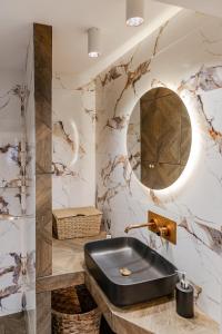 a bathroom with a black sink and a mirror at Delimare, Acropolis & Sea View Rooftop, Paleo Faliro in Athens +68 photos