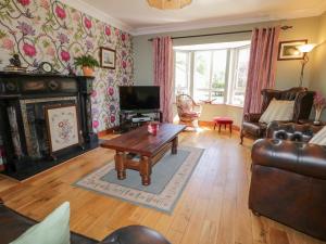 a living room with a couch and a table at Mill House 