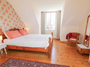 a bedroom with a bed and a window at Mill House 