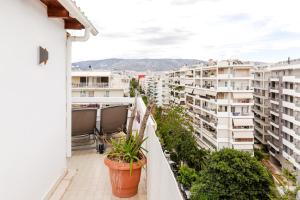 a balcony with a view of buildings at Delimare, Acropolis & Sea View Rooftop, Paleo Faliro in Athens
