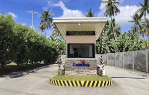 a small building with a roof on a street at Lumina Home Dumaguete in Dumaguete
