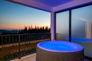 a hot tub on a balcony with a view at Villa Casa de Flores in Dubravka +47 photos