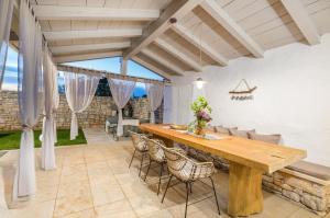a patio with a wooden table and chairs at Villa Jona in Žužići