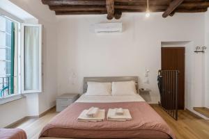 a bedroom with a bed with two towels on it at Matt House in La Spezia
