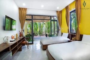 Postel nebo postele na pokoji v ubytování The Lancelynk Boutique & Pool - Bar Hoi An + 31 fotografií