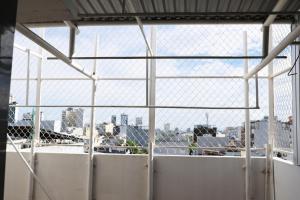 a view of a city through a chain link fence at Khách sạn Phan văn 1 in Danang