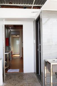 a hallway with a white wall and a room at Khách sạn Phan văn 1 in Danang +2 photos