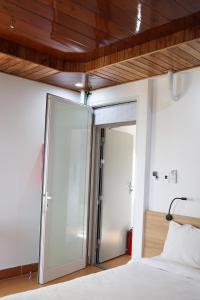 a bedroom with a glass door leading to a bed at Khách sạn Phan văn 1 in Danang