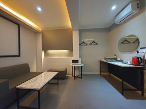 a living room with a couch and a table at Tomato Hotel in Uijeongbu