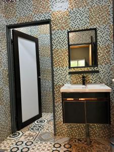a bathroom with a mirror and a sink at Woodstock Camp Chalet in Bentong