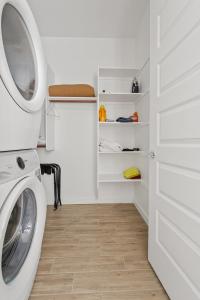 a laundry room with a washing machine and a door at Cozy & Luxe Suite in Queen Creek in Queen Creek +4 photos