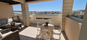 a patio with a table and chairs on a balcony at Pyla Village Resort - F302 in Pyla