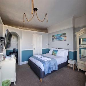 a bedroom with a bed with blue and white walls at Bayliss Hall in Weymouth