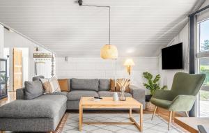 a living room with a couch and a table at Three-Bedroom Holiday Home In Thisted in Nørre Vorupør