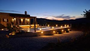 a house with lights in front of it at night at Stone Villa Halepa Pool, Sea View Peaceful Luxury in Crete in Néon Khoríon