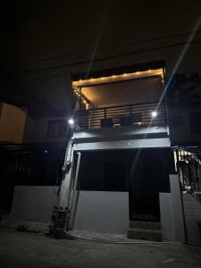 a building with a bed with lights on it at D&D Transient House in Sampong