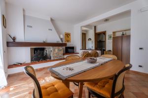 a dining room with a table and chairs and a fireplace at Villa Marisa in Stazzema