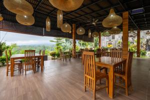 a dining room with wooden tables and chairs at Angseri Villas in Tabanan