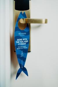 a doorhandle with a blue ribbon hanging from it at Velamar Boutique Hotel - Adults Friendly in Albufeira